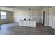 A large living area showcasing wood floors and open-concept layout for living and entertaining at 15777 W Cheryl Dr, Waddell, AZ 85355