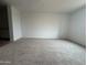 A comfortable carpeted living room with neutral tones, perfect for relaxing at 15777 W Cheryl Dr, Waddell, AZ 85355