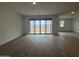 Spacious living room with wood-style floors, sliding glass doors and lots of natural light at 15777 W Cheryl Dr, Waddell, AZ 85355