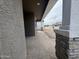 Covered porch with brick pillars and stone-paved walkway leading to the front door at 15777 W Cheryl Dr, Waddell, AZ 85355