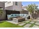 Inviting backyard featuring artificial turf, a built-in seating area, and a stone fire pit perfect for outdoor gatherings at 15837 N 74Th Ln, Peoria, AZ 85382