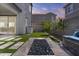 Spacious backyard featuring artificial turf, stone pavers, and a fire pit, framed by lush greenery and neighborhood views at 15837 N 74Th Ln, Peoria, AZ 85382