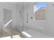 This is a bright bathroom with a window and a walk-in shower at 15837 N 74Th Ln, Peoria, AZ 85382