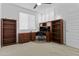 Bedroom featuring dark wood bookshelves and desk, bright natural light, and neutral walls and carpet at 15837 N 74Th Ln, Peoria, AZ 85382