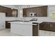 Modern kitchen featuring stainless steel appliances, quartz countertops, and a center island at 15837 N 74Th Ln, Peoria, AZ 85382