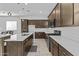 Modern kitchen with stainless steel appliances, quartz counters and pendant lighting at 15837 N 74Th Ln, Peoria, AZ 85382