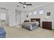 Bright main bedroom with neutral carpet and a ceiling fan at 15837 N 74Th Ln, Peoria, AZ 85382
