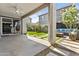 Covered patio with concrete flooring that overlooks the backyard featuring artificial grass, stone pavers, and a fire pit at 15837 N 74Th Ln, Peoria, AZ 85382