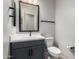 Modern bathroom features a sleek vanity with a black faucet and a toilet with accessories at 16064 W Montana De Oro Dr, Surprise, AZ 85387