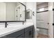 Stylish bathroom featuring double sinks, a vanity with cabinets, and a shower-tub combo at 16064 W Montana De Oro Dr, Surprise, AZ 85387