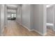 Hallway features neutral walls, and tile floors, seamlessly flowing into the spacious living area at 16064 W Montana De Oro Dr, Surprise, AZ 85387