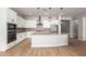 Modern kitchen featuring white cabinetry, a large island, stainless steel appliances, and brick backsplash at 16064 W Montana De Oro Dr, Surprise, AZ 85387