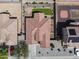 Aerial view of home with tile roof, paved driveway, and landscaped backyard with synthetic grass at 16438 W Buchanan St, Goodyear, AZ 85338