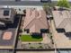Home aerial view featuring landscaped backyard with synthetic grass, tile roof, and desert landscaping at 16438 W Buchanan St, Goodyear, AZ 85338