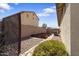 Backyard with stone landscaping and garden planters, bordered by a privacy wall at 16438 W Buchanan St, Goodyear, AZ 85338