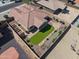 Aerial view of landscaped backyard with artificial grass, a bocce ball court, and stone patio at 16438 W Buchanan St, Goodyear, AZ 85338