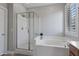 Bathroom featuring a separate shower and soaking tub with bright natural light at 16438 W Buchanan St, Goodyear, AZ 85338