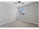 Bedroom featuring carpet flooring, ceiling fan, and a window with shutters at 16438 W Buchanan St, Goodyear, AZ 85338