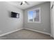 Neutral bedroom with a ceiling fan, a window with shutters, and carpet at 16438 W Buchanan St, Goodyear, AZ 85338