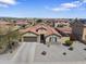 Attractive single-story home featuring a tile roof, neutral stucco, a two-car garage, and desert landscaping at 16438 W Buchanan St, Goodyear, AZ 85338