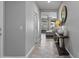 Inviting hallway with tile flooring, a decorative console table, and views into the living room at 16438 W Buchanan St, Goodyear, AZ 85338