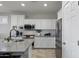 Modern kitchen with white cabinets, stainless steel appliances, subway tile backsplash, and sleek countertops at 16438 W Buchanan St, Goodyear, AZ 85338