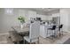 Bright kitchen features white cabinets, stainless steel appliances and a large island with bar seating at 16438 W Buchanan St, Goodyear, AZ 85338