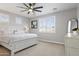 Bright and serene main bedroom with plush carpet, fan, shuttered windows, and stylish decor at 16438 W Buchanan St, Goodyear, AZ 85338