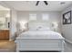 Relaxing main bedroom with a white bed frame, bedside lamps and neutral decor at 16438 W Buchanan St, Goodyear, AZ 85338