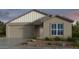 Charming single-story home with a neutral color palette, well-manicured landscaping, and an attached two-car garage at 17153 W Sweet Iron Pass, Surprise, AZ 85387