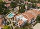 Stunning aerial view of homes with terracotta roofs, mature landscaping, and a community pool at 1717 E Union Hills Dr # 1110, Phoenix, AZ 85024