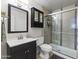 Bathroom featuring a vanity, decorative mirror, toilet, and shower with glass doors at 1717 E Union Hills Dr # 1110, Phoenix, AZ 85024