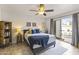 Bright bedroom featuring neutral walls, a ceiling fan, and sliding glass door to the patio at 1717 E Union Hills Dr # 1110, Phoenix, AZ 85024