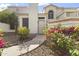 Inviting front entrance with blooming bougainvillea, creating a welcoming pathway to the home at 1717 E Union Hills Dr # 1110, Phoenix, AZ 85024