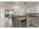 Cozy kitchen with tiled floors, breakfast bar, and view into the living room and fireplace at 1717 E Union Hills Dr # 1110, Phoenix, AZ 85024