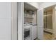 Laundry room featuring a washer, dryer, shelves, and closet leading to a shower at 1717 E Union Hills Dr # 1110, Phoenix, AZ 85024