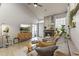 Comfortable living room featuring a stone fireplace, plush seating, and natural light from the sliding door at 1717 E Union Hills Dr # 1110, Phoenix, AZ 85024