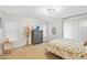 Bright bedroom with a floral-patterned bedspread, neutral walls, and modern chandelier at 1920 E Bell Rd # 1034, Phoenix, AZ 85022