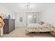 Bright bedroom with a floral-patterned bedspread, neutral walls, and modern chandelier at 1920 E Bell Rd # 1034, Phoenix, AZ 85022