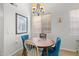 Charming dining area with round table, upholstered chairs, and a modern chandelier at 1920 E Bell Rd # 1034, Phoenix, AZ 85022