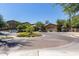 The community entrance is enhanced by well-maintained landscaping and circular brick pavers at 1920 E Bell Rd # 1034, Phoenix, AZ 85022