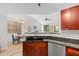 Modern kitchen with dark granite countertops, and an open view to the living and dining areas at 1920 E Bell Rd # 1034, Phoenix, AZ 85022