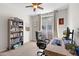 Bright office with large desk, full bookshelf, and sliding glass door to balcony at 1920 E Bell Rd # 1034, Phoenix, AZ 85022