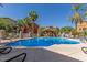 Community pool with clear blue water, palm trees, lounge chairs and a gazebo offers a resort-like experience at 1920 E Bell Rd # 1034, Phoenix, AZ 85022