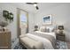 Comfortable bedroom with soft lighting, neutral decor, plush bedding, and a cozy atmosphere at 20373 W Rovey Ave, Buckeye, AZ 85396