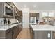 Modern kitchen featuring stainless steel appliances, white countertops, wood flooring, and sleek, dark wood cabinetry at 20373 W Rovey Ave, Buckeye, AZ 85396