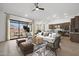 Open-concept living room featuring modern furnishings, neutral tones, and seamless access to the outdoor patio at 20373 W Rovey Ave, Buckeye, AZ 85396