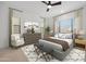 Spacious main bedroom with a ceiling fan, neutral decor, large windows, and comfortable furnishings at 20373 W Rovey Ave, Buckeye, AZ 85396