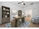Bright home office featuring a modern desk, ample storage, and a comfortable accent chair at 20373 W Rovey Ave, Buckeye, AZ 85396