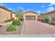 Charming home featuring a brick driveway, well-maintained landscaping, and a two-car garage in a desirable community at 2041 N 88Th St, Mesa, AZ 85207